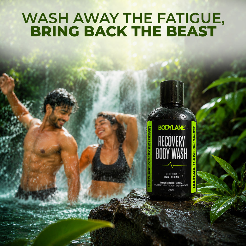 Two people under a waterfall with a Bodylane Recovery Body Wash bottle in the foreground.