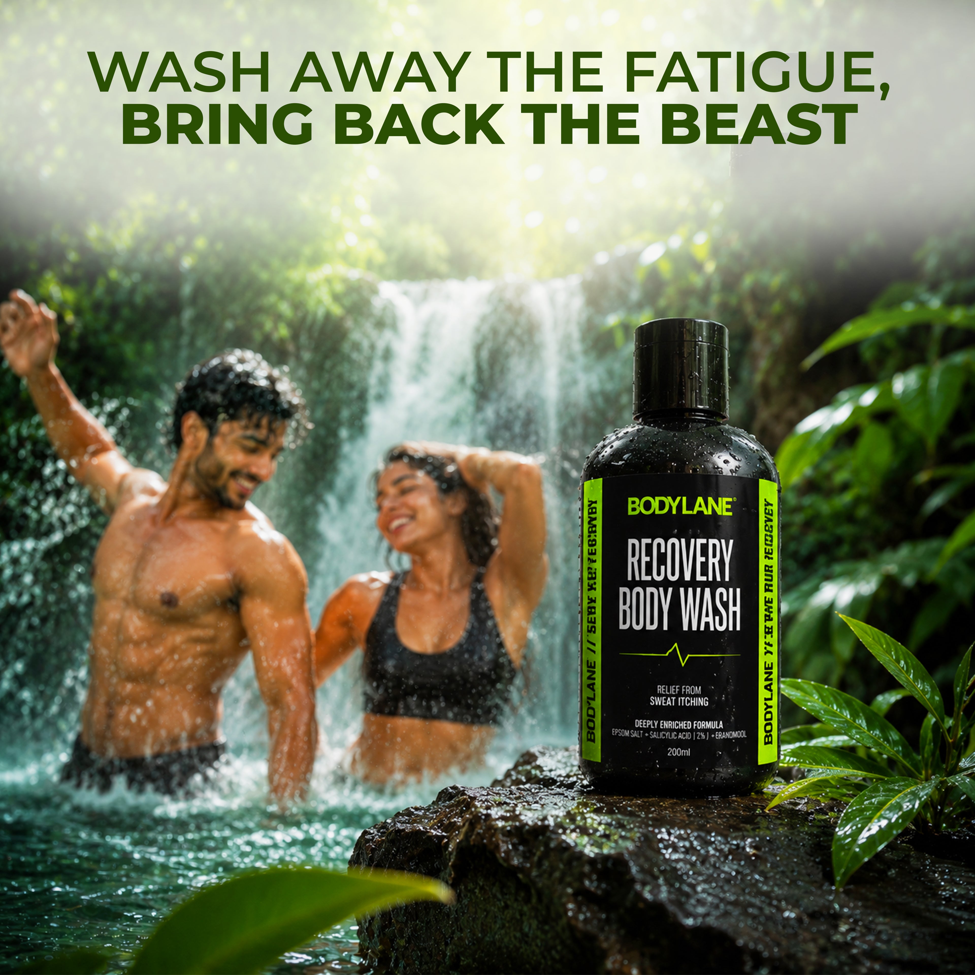 Two people under a waterfall with a Bodylane Recovery Body Wash bottle in the foreground.